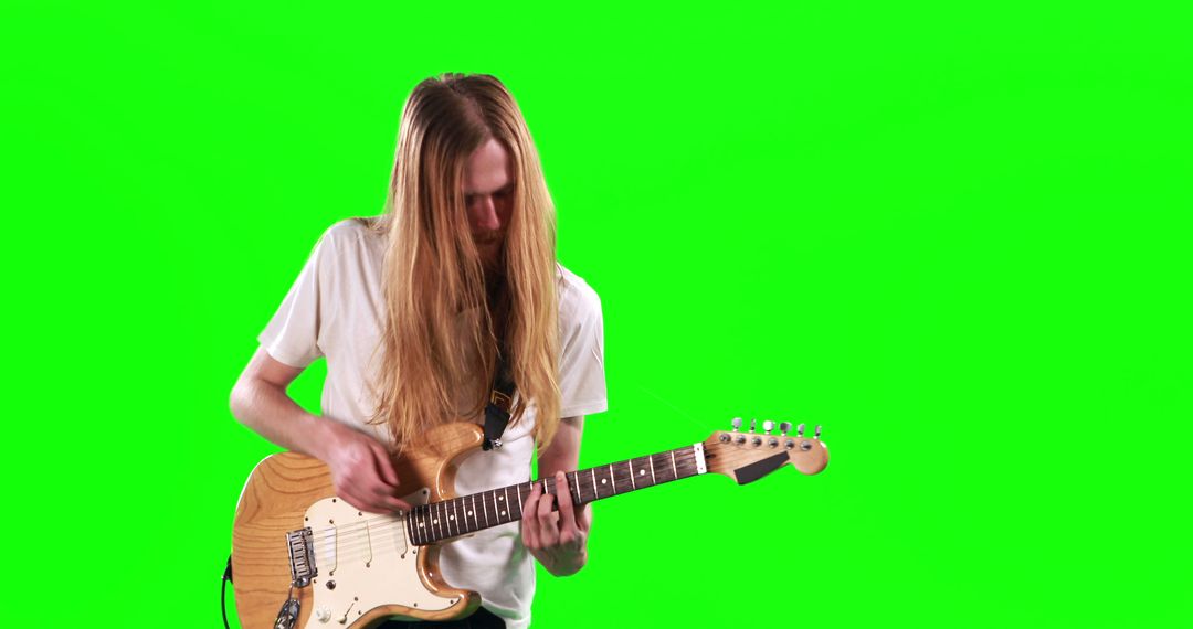 Young Musician with Electric Guitar Performing on Green Screen - Free Images, Stock Photos and Pictures on Pikwizard.com
