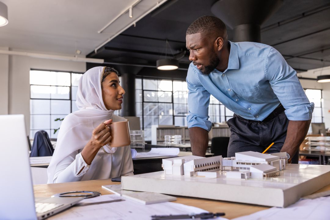 Diverse Coworkers Collaborating on Architectural Project