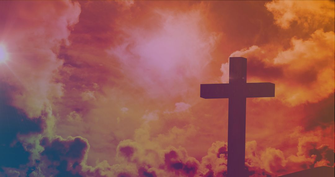 Dramatic Spiritual Cross Against Fiery Sky