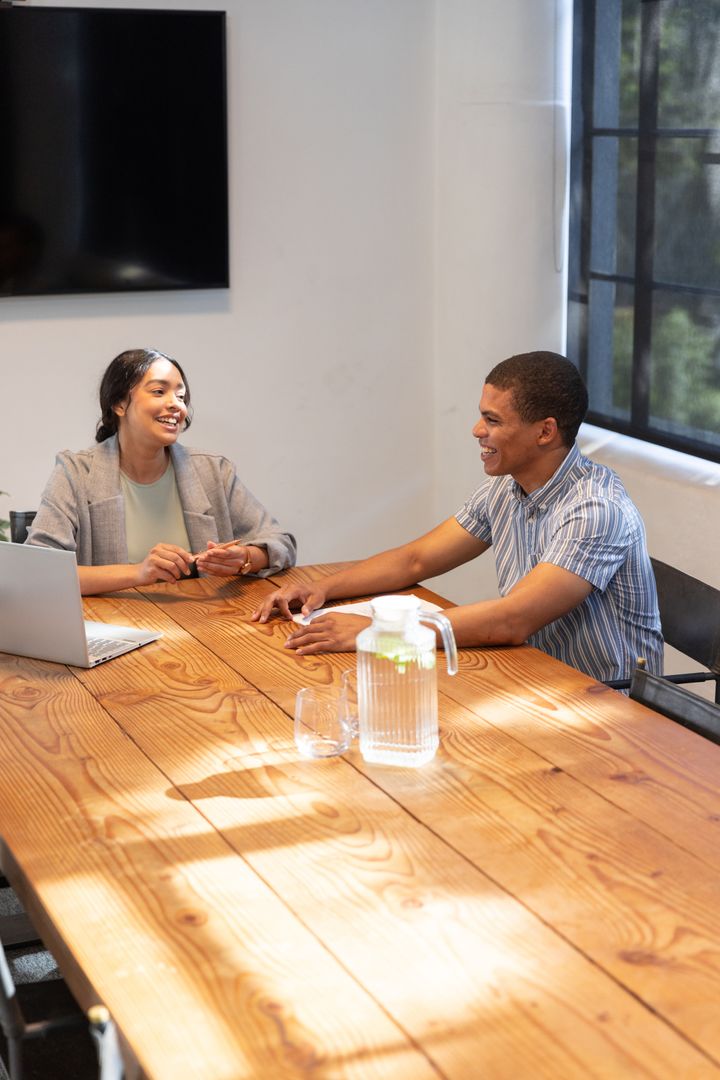 Business Meeting Between Colleagues with Laptops and Pitchers