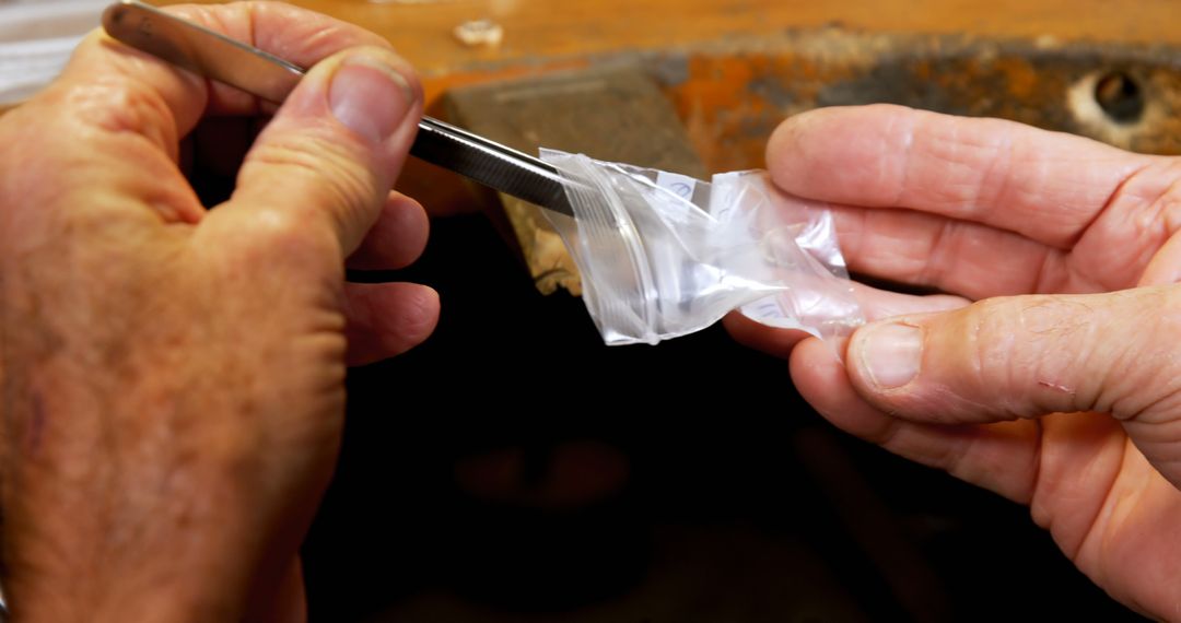 Elderly Hands Handling Small Plastic Bag with Tweezers - Free Images, Stock Photos and Pictures on Pikwizard.com