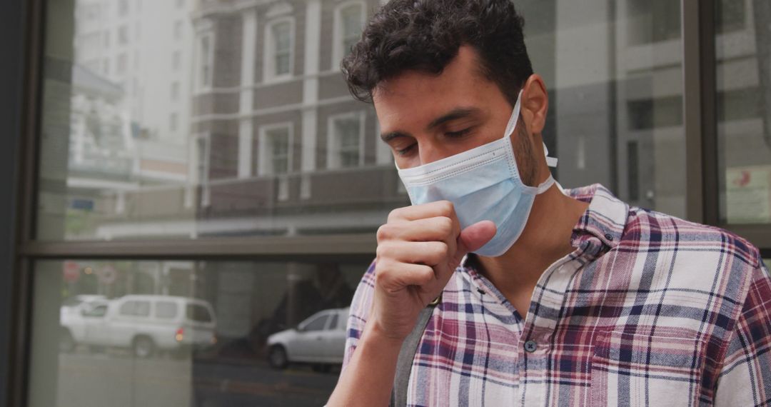 Man Wearing Protective Face Mask Coughing Outside Urban Building - Free Images, Stock Photos and Pictures on Pikwizard.com