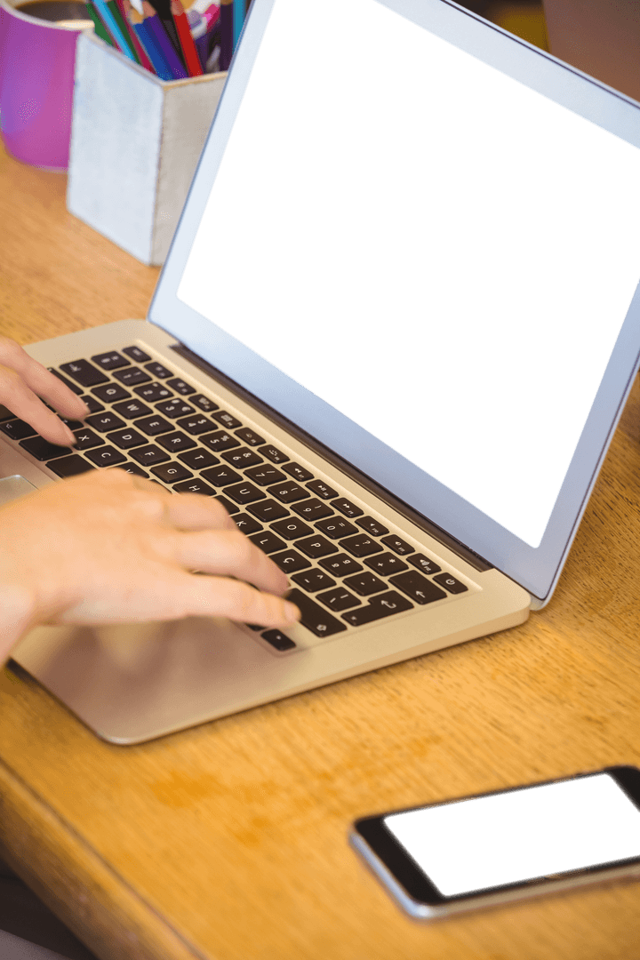 Man Typing on Laptop with Transparent Screen in Office