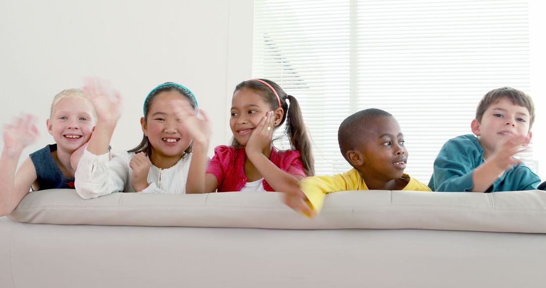 Diverse Group of Children Smiling and Waving on Sofa - Free Images, Stock Photos and Pictures on Pikwizard.com