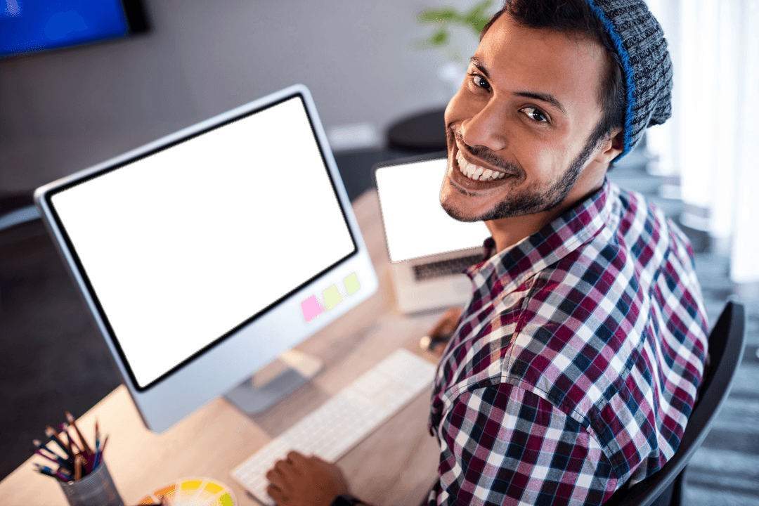Joyful Man Smiling at Office with Blank Computer Screens