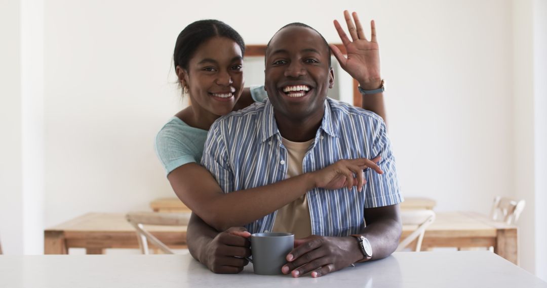 Joyful Young Couple Embracing at Bright Home