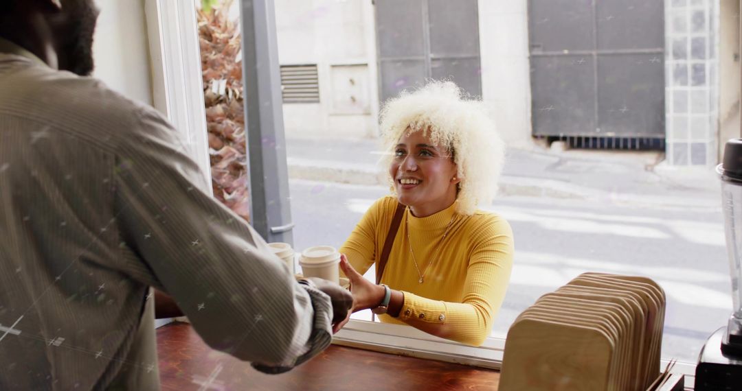Happy Customer Receiving Coffee at Open Service Window in Cozy Cafe