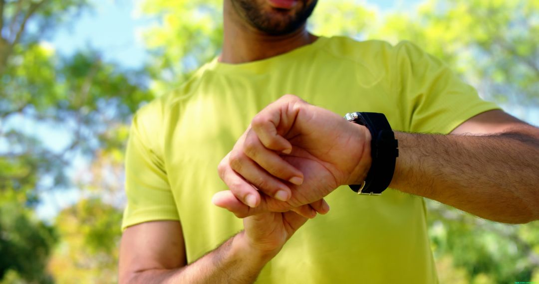 Man Checking Smartwatch in Park - Free Images, Stock Photos and Pictures on Pikwizard.com