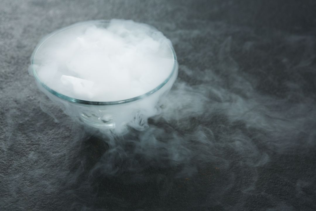 Dry Ice Smoke in Glass Bowl on Dark Surface - Free Images, Stock Photos and Pictures on Pikwizard.com
