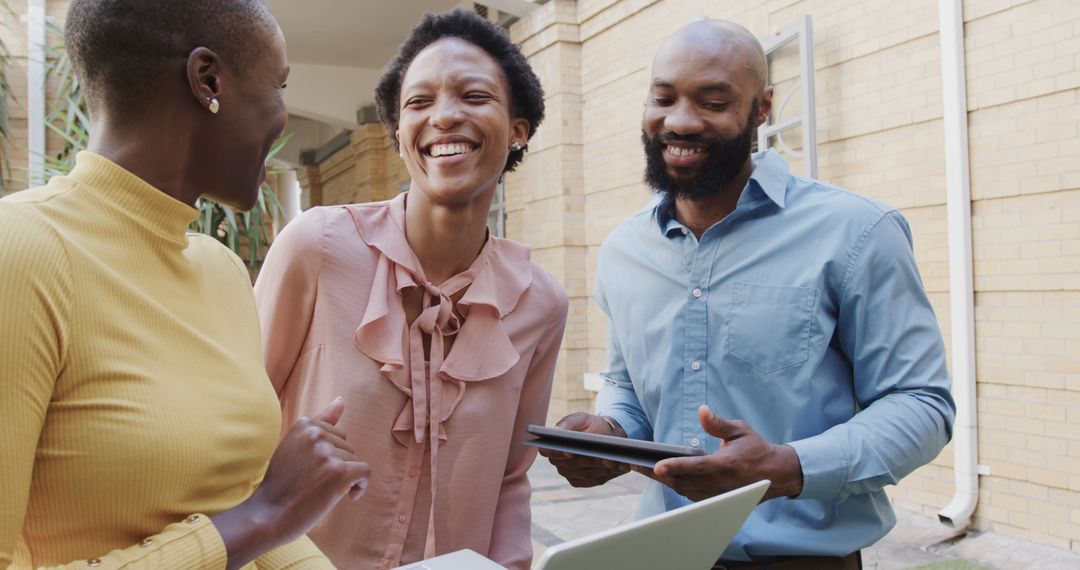Diverse Colleagues Collaborating and Laughing at Work