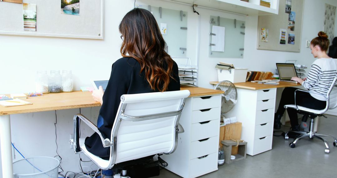 Women Working in Modern Office Space with Spacious Desks and Storage - Free Images, Stock Photos and Pictures on Pikwizard.com