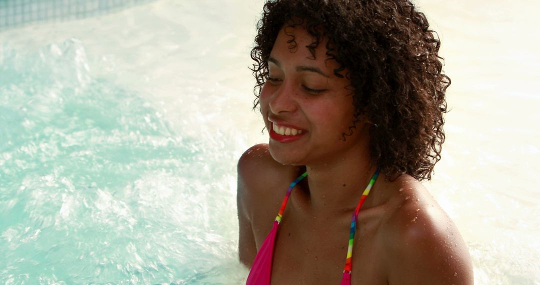 Cheerful Young Woman Enjoying Pool Time with Smile - Free Images, Stock Photos and Pictures on Pikwizard.com