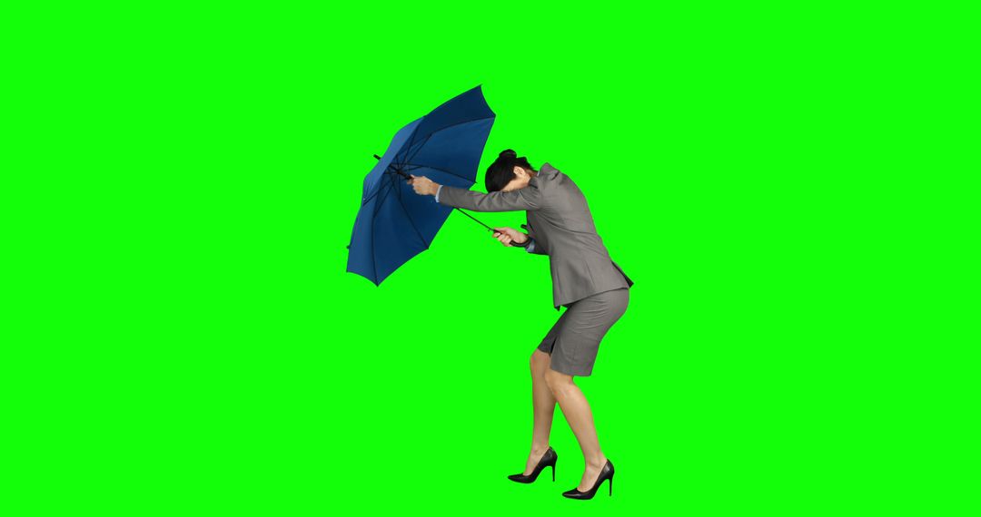 Businesswoman Struggling with Umbrella Against Wind on Green Screen - Free Images, Stock Photos and Pictures on Pikwizard.com