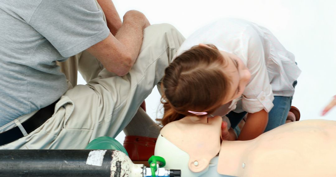 Child Practicing CPR on Dummy During First Aid Training Class - Free Images, Stock Photos and Pictures on Pikwizard.com