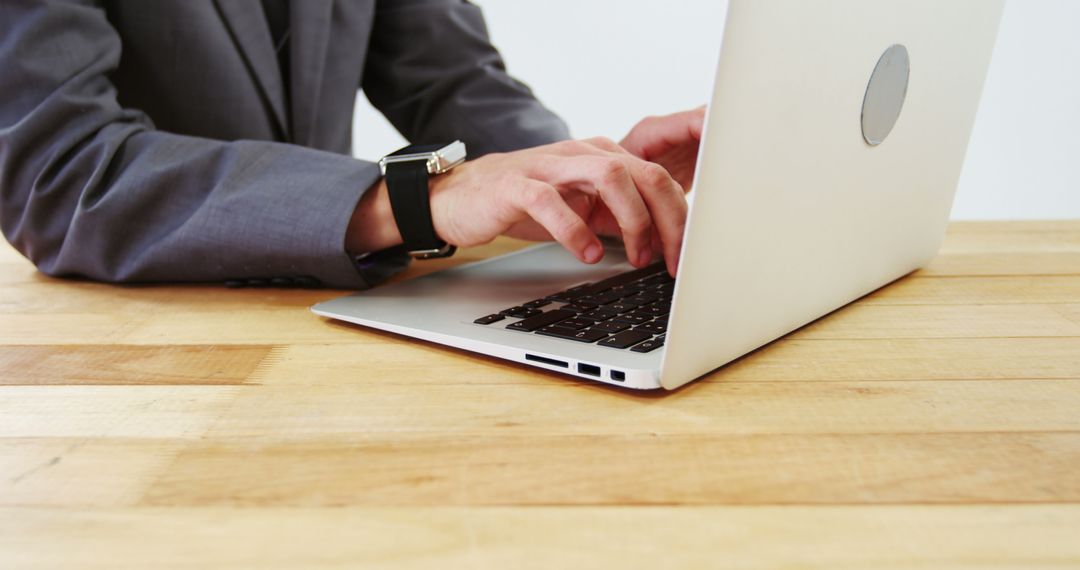 Businessman Typing on Laptop in Office Environment
