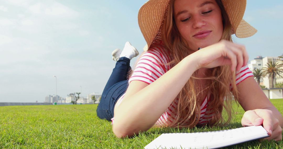 Young Woman Enjoying Relaxation and Reading Outdoors on Sunny Day - Free Images, Stock Photos and Pictures on Pikwizard.com