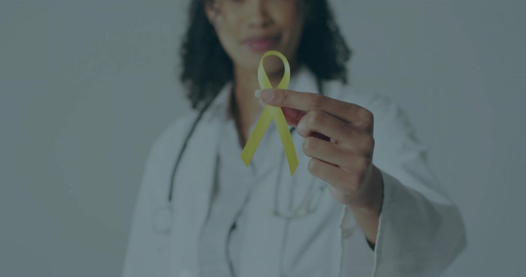 Female Doctor Holding Yellow Awareness Ribbon for Health Advocacy