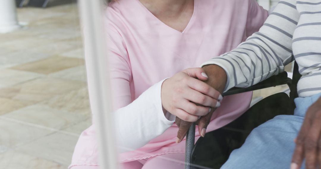 Nurse comforting elderly person in wheelchair - Free Images, Stock Photos and Pictures on Pikwizard.com