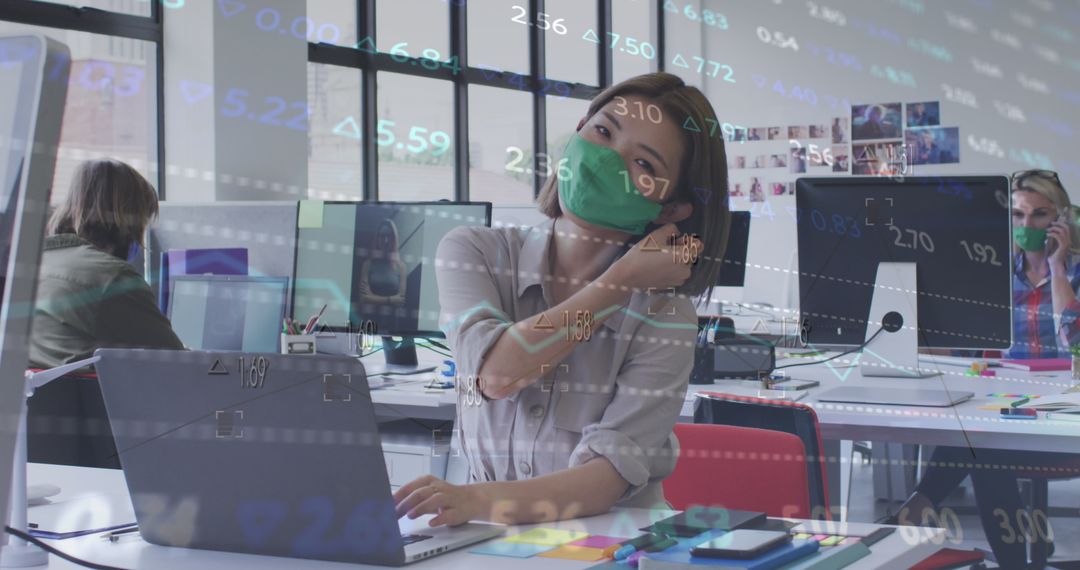 Businesswoman Removing Mask in Cutting-edge Office with Digital Overlay