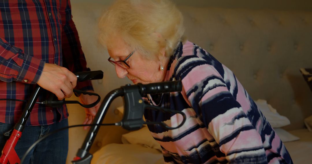 Elderly Woman Receiving Assistance with Walker by Caregiver - Free Images, Stock Photos and Pictures on Pikwizard.com