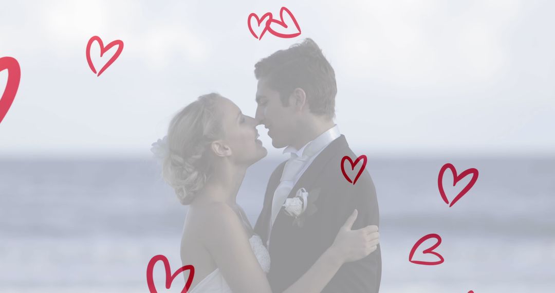 Romantic Beach Wedding with Joyful Couple Kissing Under Red Hearts