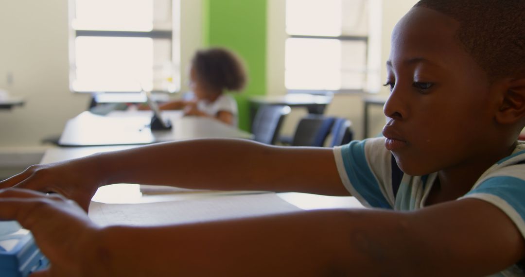 Young Schoolboy Engaging in Classroom Learning Activity