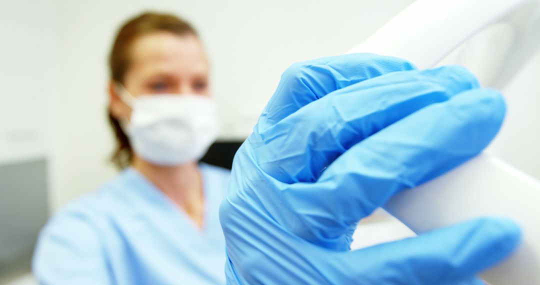 Healthcare Worker Wearing Gloves Holding Medical Equipment - Free Images, Stock Photos and Pictures on Pikwizard.com