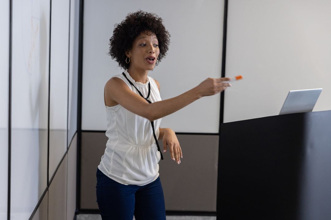 Female Educator Engaging in Interactive Workshop with Students