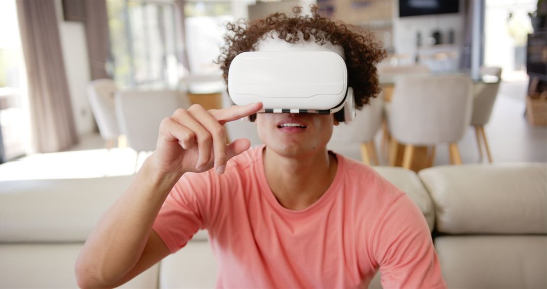 Young Man Immersed in Virtual Reality Technology at Home
