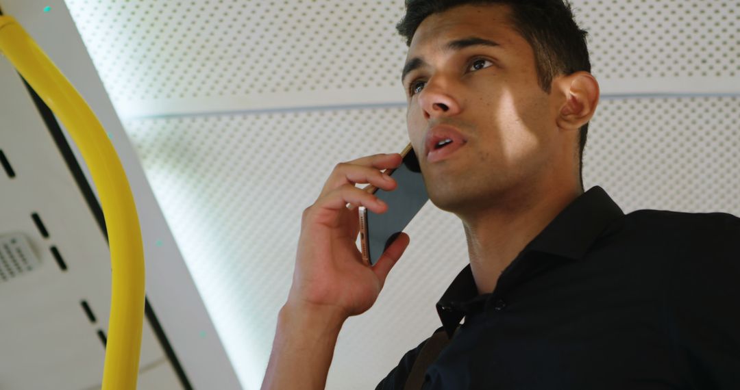 Young Man in Black Shirt Talking on Phone in Train - Free Images, Stock Photos and Pictures on Pikwizard.com