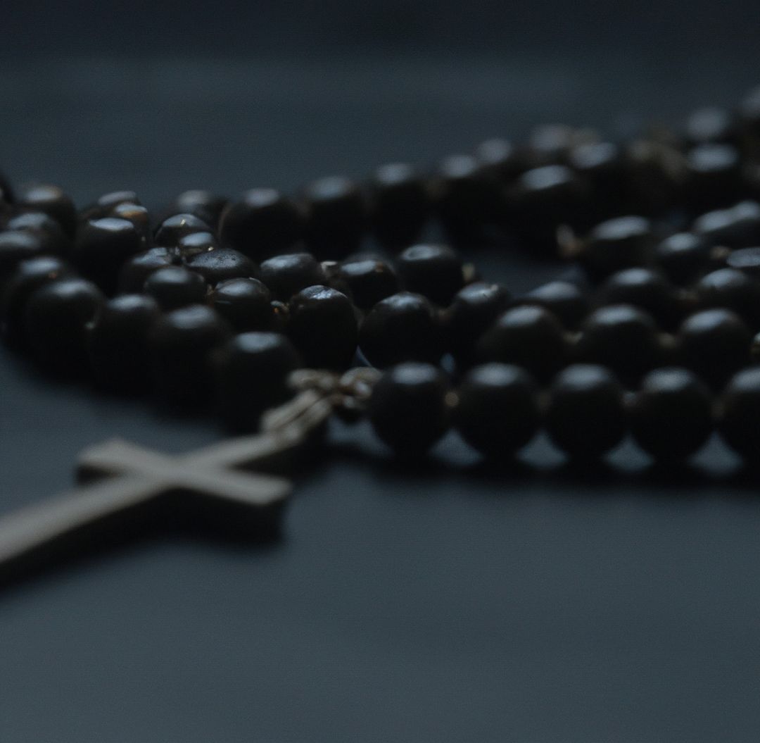 Close up of black rosary with cross on black background - Free Images, Stock Photos and Pictures on Pikwizard.com
