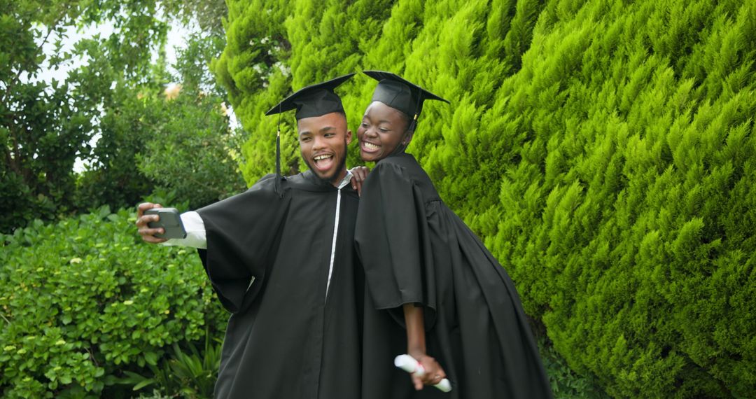 Joyful Graduating Students Celebrating Success with Selfie