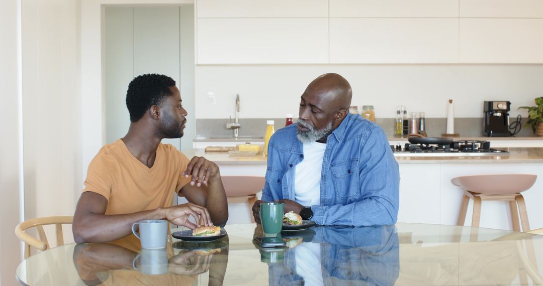 Father and Son Sharing Meal in Modern Kitchen