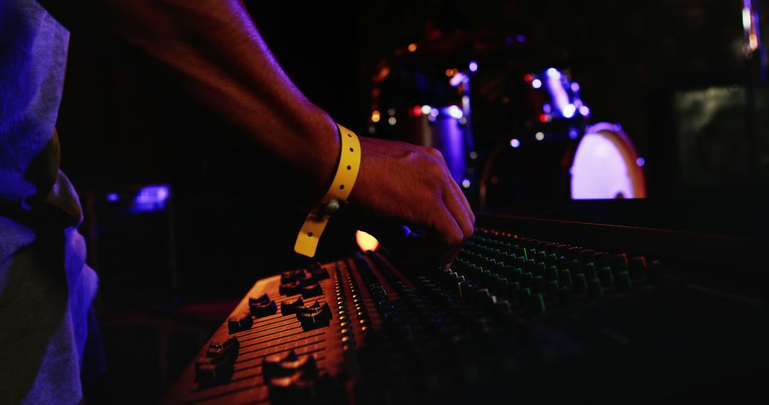 Sound Engineer Adjusting Audio Mixing Console at Concert - Free Images, Stock Photos and Pictures on Pikwizard.com