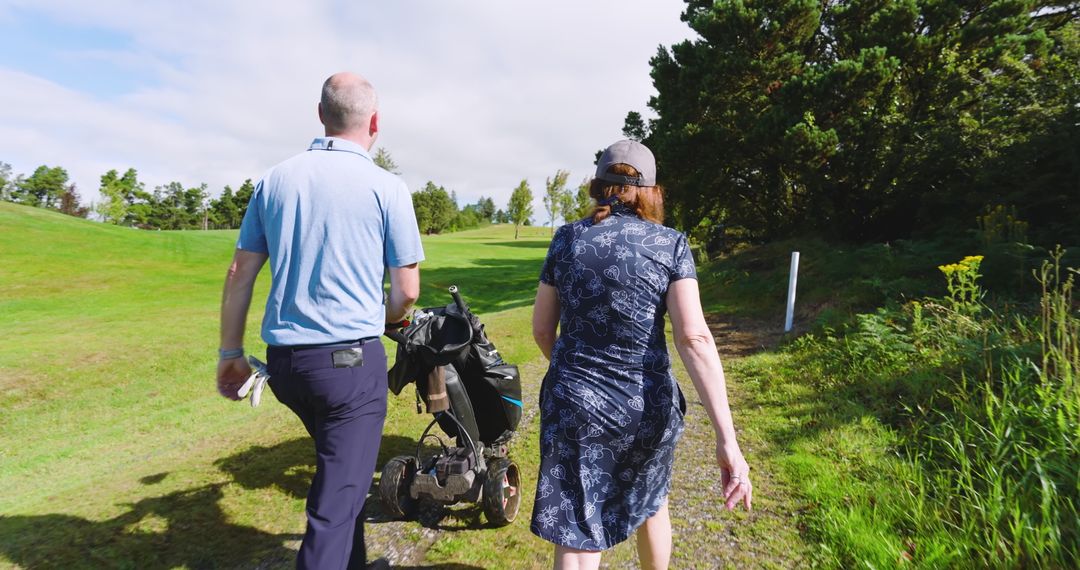 Mother and Son Walking on Golf Course in Golf Attire