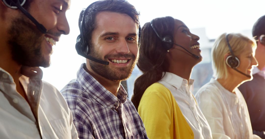 Customer Service Team Smiling While Wearing Headsets in Bright Office - Free Images, Stock Photos and Pictures on Pikwizard.com