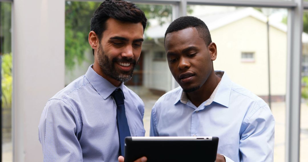 Diverse Businessmen Collaborating on Tablet Technology
