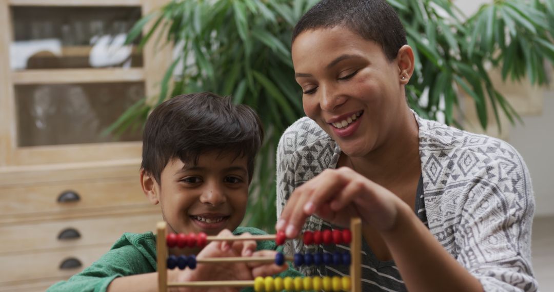 Smiling Mother and Son Learning Together at Home with Abacus - Free Images, Stock Photos and Pictures on Pikwizard.com