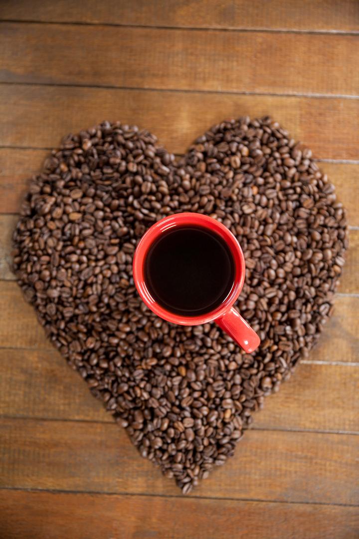 Coffee cup with heart shaped coffee beans - Free Images, Stock Photos and Pictures on Pikwizard.com