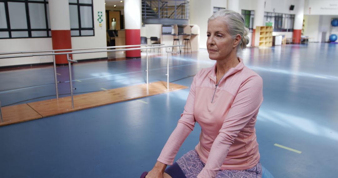 Thoughtful Caucasian Woman Taking Moment in Spacious Gym - Free Images, Stock Photos and Pictures on Pikwizard.com