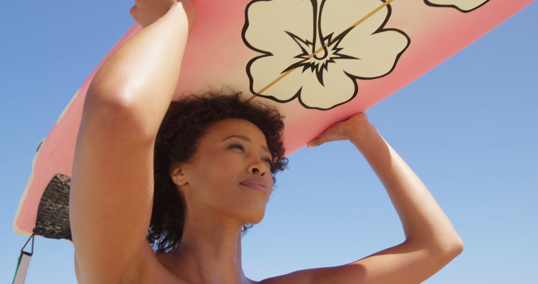 Female Surfer Holding Surfboard with Floral Design at Beach - Free Images, Stock Photos and Pictures on Pikwizard.com