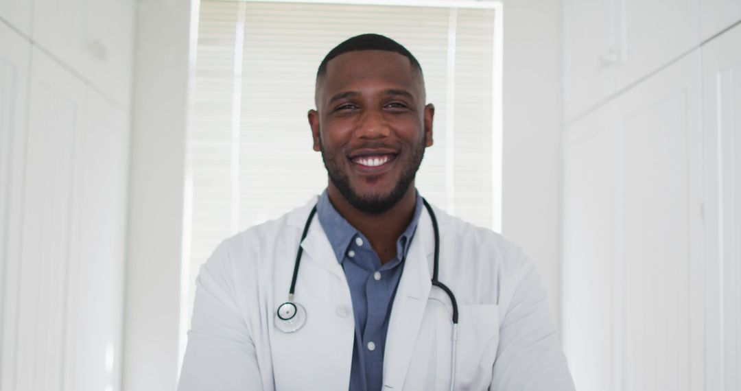 Smiling African American Doctor in White Coat with Stethoscope - Free Images, Stock Photos and Pictures on Pikwizard.com