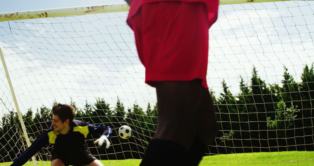 Soccer Player Scoring Goal, Goalkeeper Attempting Save on Green Field - Free Images, Stock Photos and Pictures on Pikwizard.com