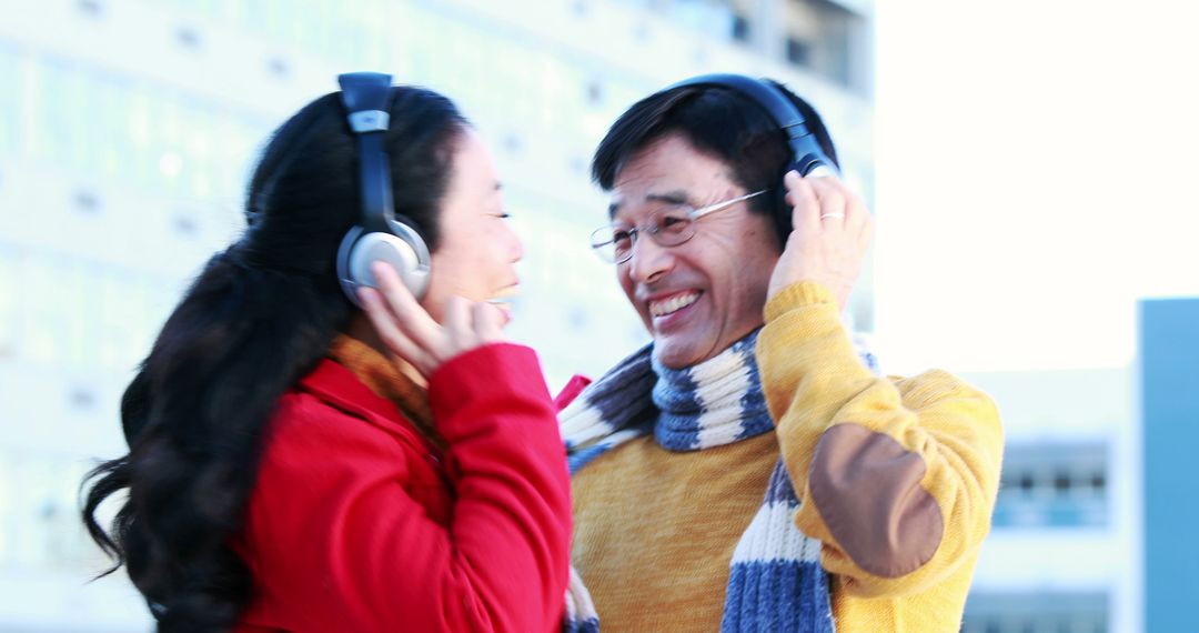 Couple Enjoying Music Together with Headphones in Urban Setting - Free Images, Stock Photos and Pictures on Pikwizard.com