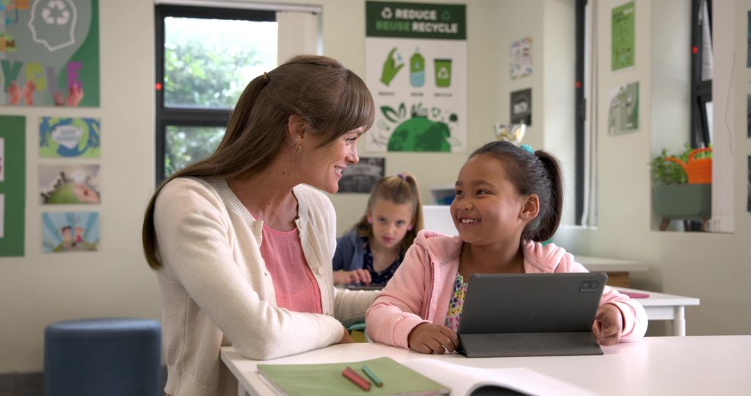Teacher Assisting Diverse Elementary Student with Tablet in Classroom