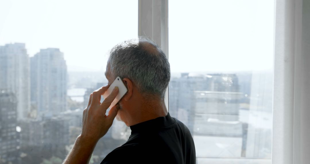 Senior Man Talking on Phone in Modern Apartment - Free Images, Stock Photos and Pictures on Pikwizard.com