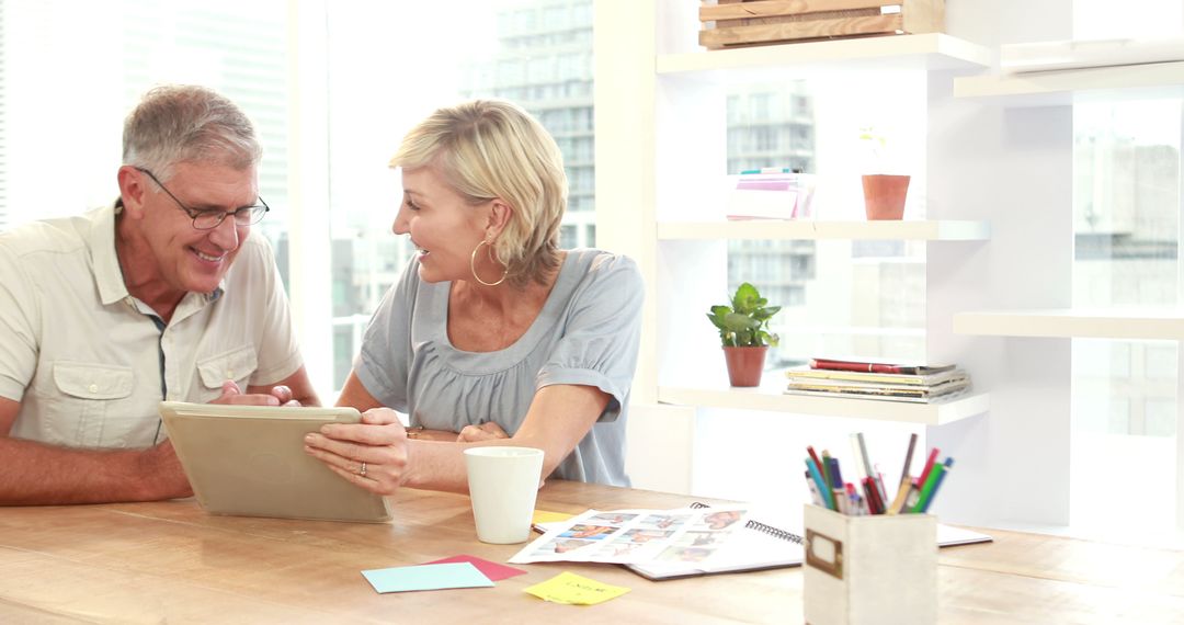 Caucasian Middle-Aged Couple Planning with Digital Tablet