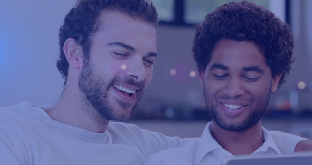 Joyful Diverse Gay Couple Celebrating with Technology
