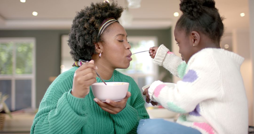 Mother and Daughter Enjoying Breakfast Time Together - Free Images, Stock Photos and Pictures on Pikwizard.com