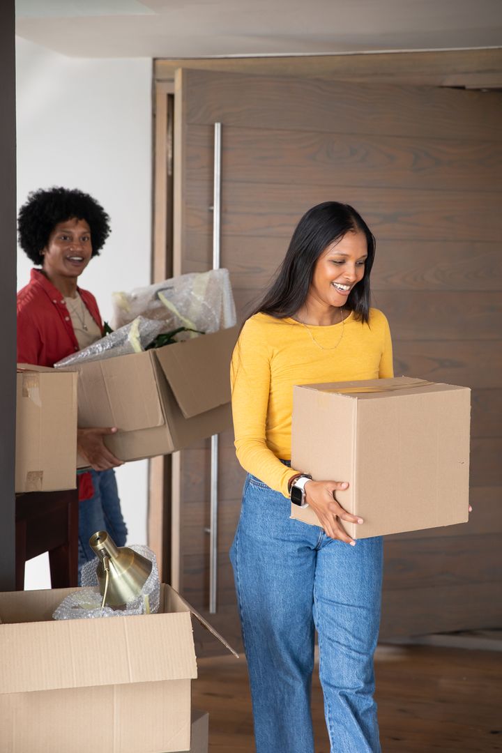 Couple Relocating into New Home with Cardboard Boxes